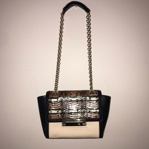 Cream, black, and animal print purse